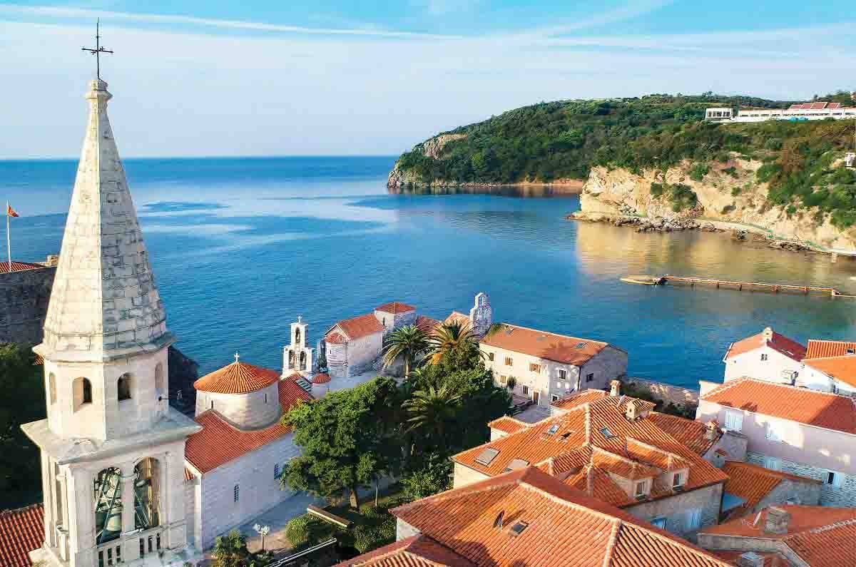 The view of old town Budva, with its houses and sacral objects inside fortified walls.